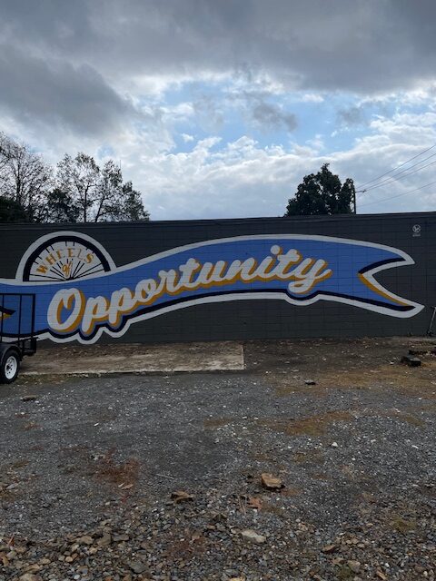 A mural outside the building that reads "Opportunity"